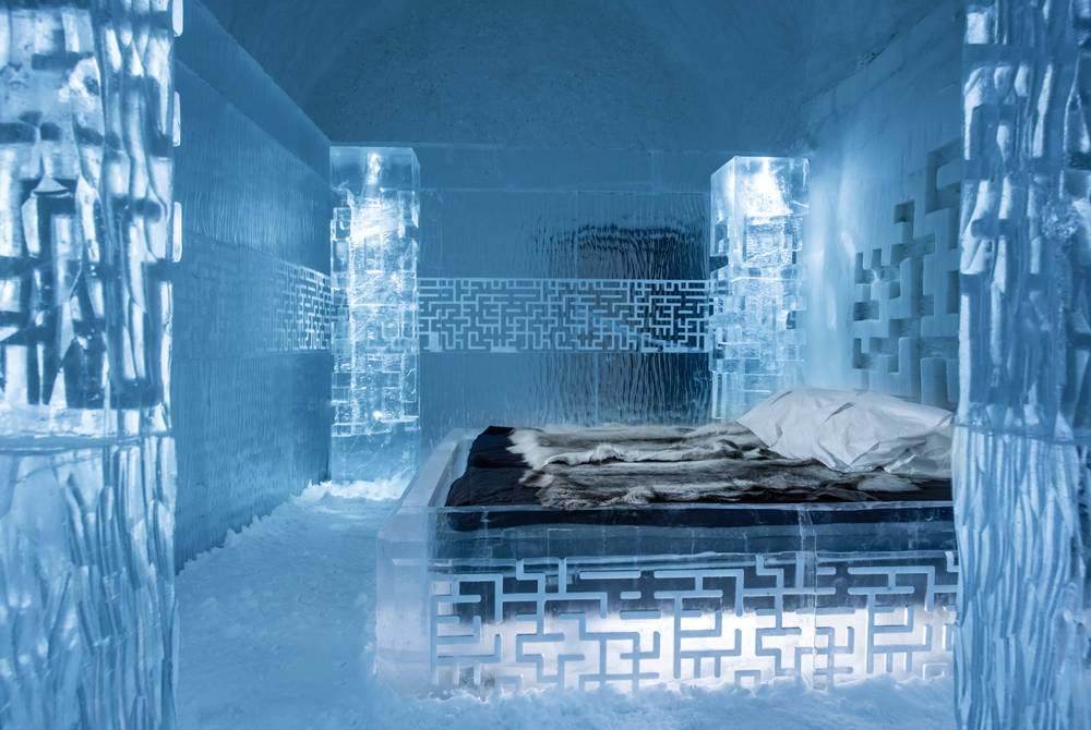 Vaulted corridor of packed snow with carved openings along both sides