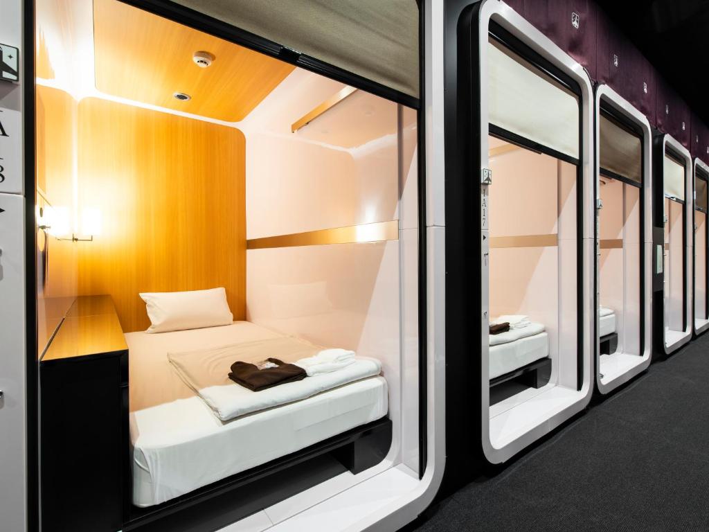 Corridor of enclosed sleeping cabins with sliding screens along one side