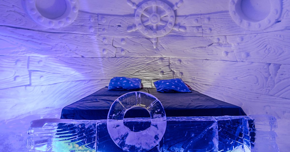 Snow-walled sleeping chamber with a low platform and a carved recess
